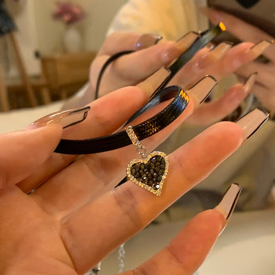 Black heart earrings with sparkling diamonds