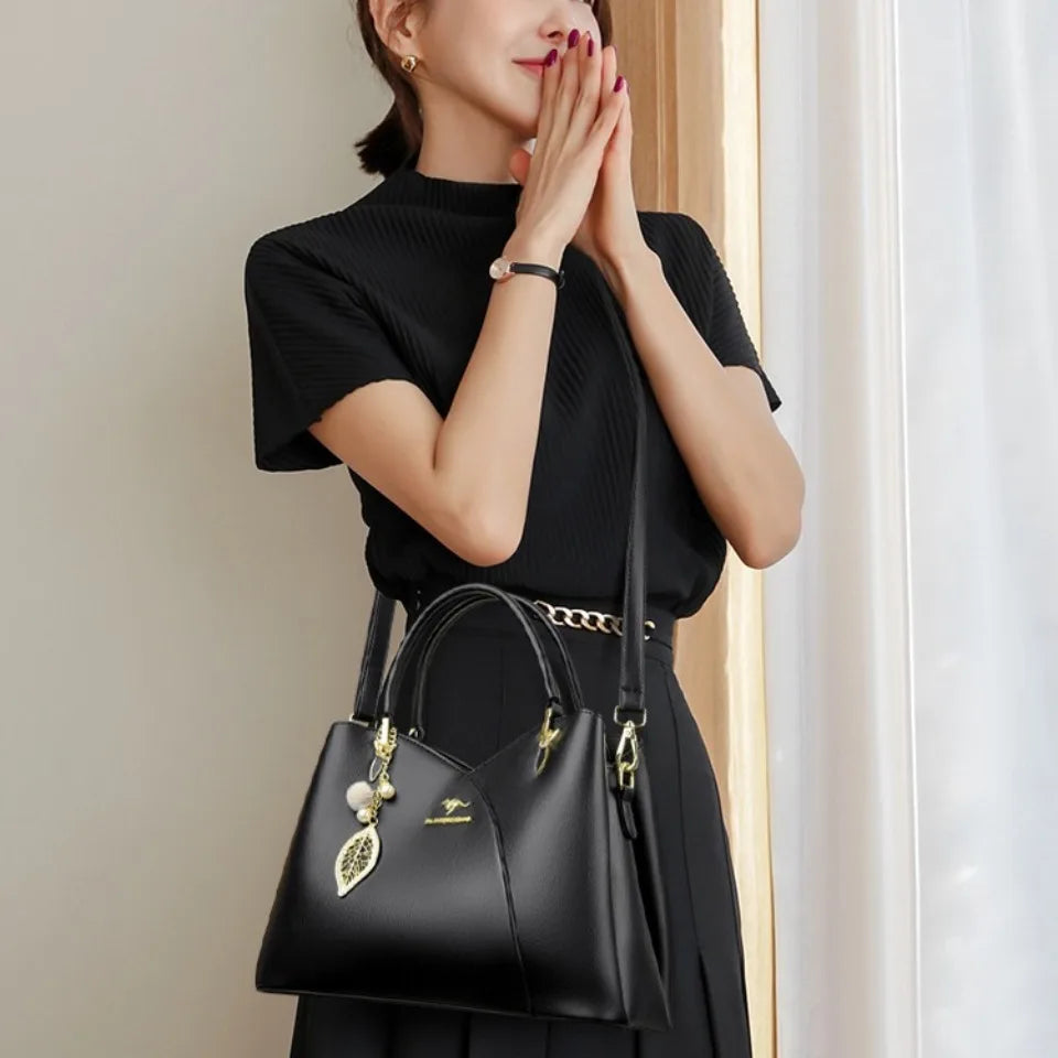 felina™ – black shoulder bag with elegant pendants